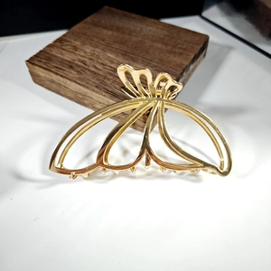 Elegant golden butterfly hair claw clip with cutout design and metallic finish for women