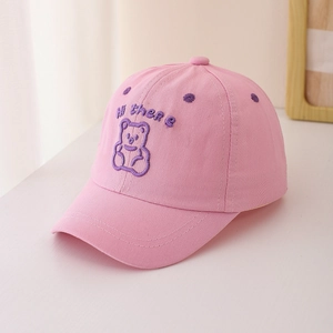 Close-up of pink cotton baseball cap featuring bear embroidery and Hi there text detail