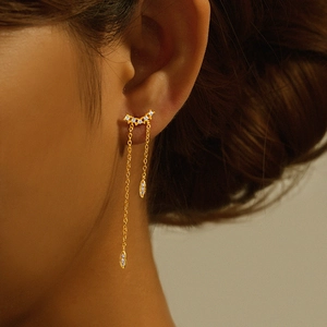 Macro detail of gold S925 sterling silver tassel earrings with sparkling diamond fringe