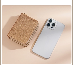 Detail view of the rose gold glitter card holder next to a phone showing portable size