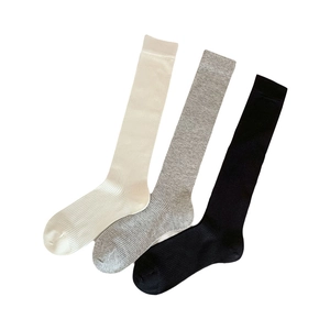 Knee-high ribbed socks in cream white, light grey, and black colors for a sleek ballet look
