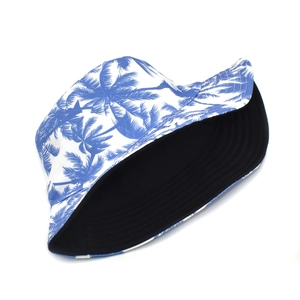 Detail of reversible bucket hat with blue coconut tree print and plain black interior side