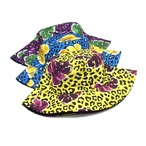 Detail showing various colors of leopard and tropical leaf print bucket hats