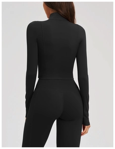 Rear view of slim-fit yoga jacket showing structural back seams and high-waist leggings
