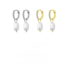 Close-up of 925 silver and gold baroque pearl drop earrings with zircon crystals