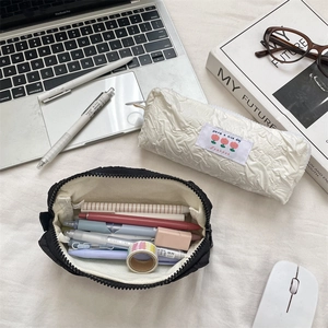Detail of high-capacity pencil case showing tulip patch and organized stationery storage