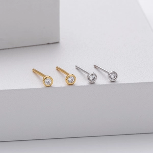 Detailed close-up of S925 sterling silver stud earrings with round cubic zirconia in gold