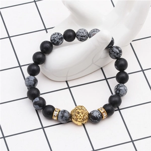 Beaded bracelet featuring snowflake obsidian, black matte beads, and a golden lion head