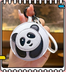 Close-up of a round panda themed PU leather coin purse with black hook and white strap