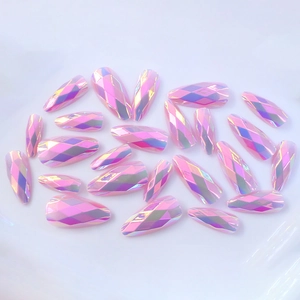 Macro view of long almond press-on nails with 3D diamond cut and purple aurora finish