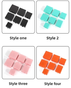 Detail of colorful drawer jewelry boxes with ribbon pulls in four vibrant colors