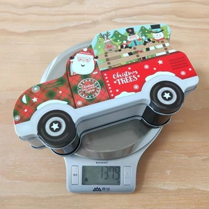 Christmas truck tin box weight measurement on digital kitchen scale 1379g