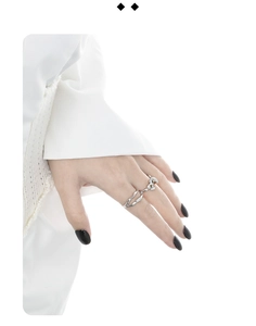 Close-up of irregular wave silver rings with diamonds worn on hand for a minimalist look