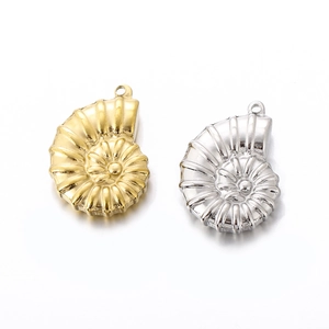 Macro detail of gold and silver seashell pendants with spiral textures for DIY jewelry