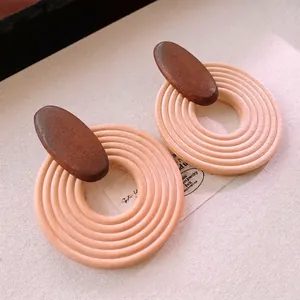 Bohemian retro wood earrings with pink textured circles and dark oval accents