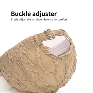 Adjustable khaki seersucker baseball cap featuring a unique pleated texture and metal buckle
