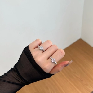Close-up of S925 silver rings with oval pink and white zircon stones on model's hand