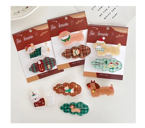 Detailed view of Christmas themed acetate hair clips featuring dogs and cats designs
