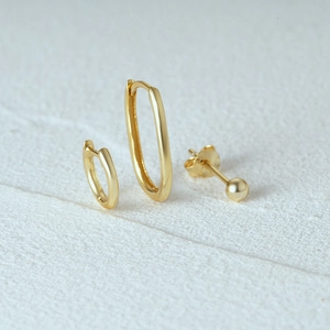 Detailed macro view of minimalist gold s925 silver turquoise style earring set components
