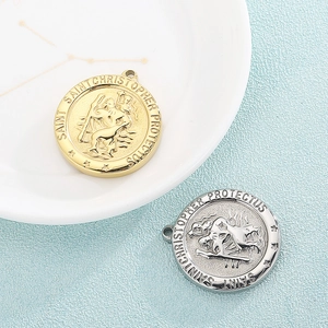 Vintage Saint Christopher pendants in gold and silver steel on a textured background