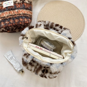 Detailed interior view of plush tote bags showing smooth zippers and soft faux fur textures