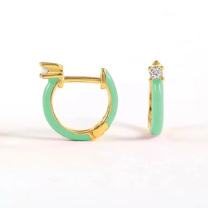Detail of mint green enamel hoop earrings with gold plating and cubic zirconia inlay