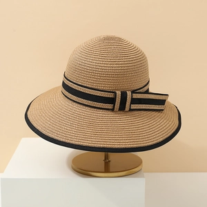 Detailed straw sun hat texture with elegant black ribbon bow on a display stand