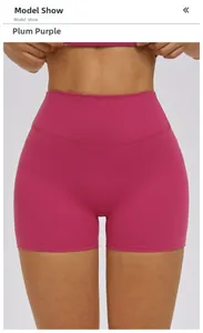 Detail of high-waisted magenta yoga shorts showing compression fabric and butt-lifting fit