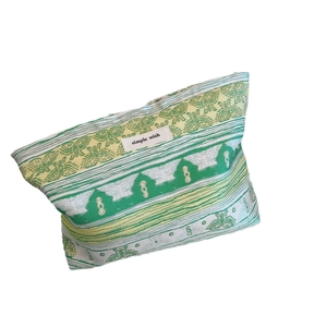 Green jacquard fabric makeup bag with floral patterns and Simple Wish woven label