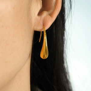 Elegant gold teardrop earrings for women in French minimalist style on model