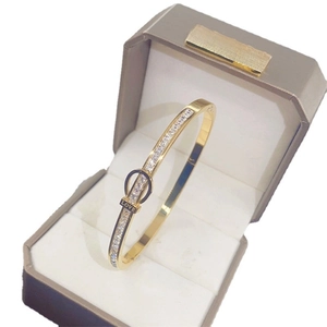 Golden horseshoe buckle bangle with inlaid diamonds and LOVE engraving in gift box