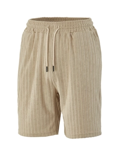 Detail view of men's khaki shorts with vertical corduroy texture and drawstring waist
