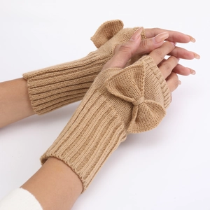 Close-up of camel knit fingerless gloves featuring a cute bow detail and soft texture