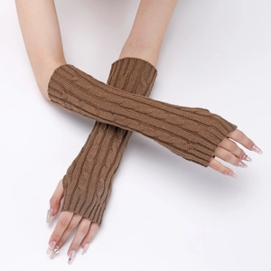 Detailed close-up of brown cable knit arm warmers showing thick braided texture