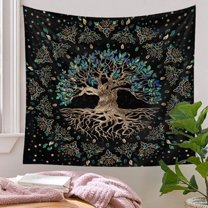Detail of bohemian tree of life tapestry hanging on a white wall in a cozy room