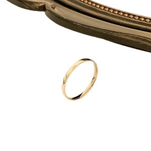 Sparkling faceted titanium steel ring for women in gold finish with a minimalist design