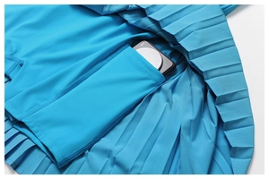 Detail of blue pleated tennis skort with hidden side pocket and inner safety liner