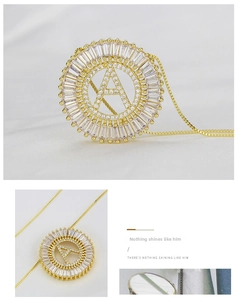 Macro detail of a gold letter A pendant with sparkling cubic zirconia on white silk