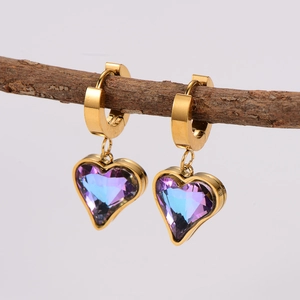 Elegant gold heart earrings with purple-blue gradient crystal on a natural branch
