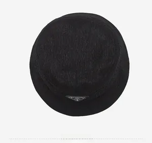 Top view of a black bucket hat with vertical stripe texture and fashion triangle logo