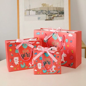 Three red paper gift bags with baby unicorn patterns in small, medium, and large sizes