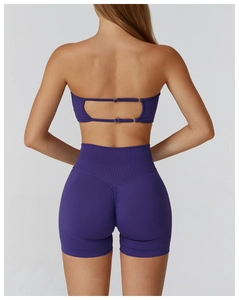 Detail of seamless purple yoga bra with hollow out back design and matching high waist shorts