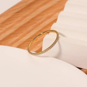 Polished 18k gold plated stainless steel ring with micro-pave crystals on white stand