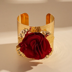 Golden metallic cuff bracelet featuring a large dark red fabric rose flower and gold leaves