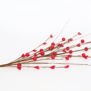 Artificial red berry branches for Christmas holiday decor on a clean white background