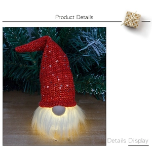 Detail showing a glowing Christmas gnome with red sequined hat and warm LED light effect