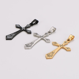 Detailed view of vintage cross pendants in black, silver, and gold with intricate engravings