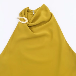 Sleeveless mustard yellow halter top with gold metal ring and elegant pleated neckline