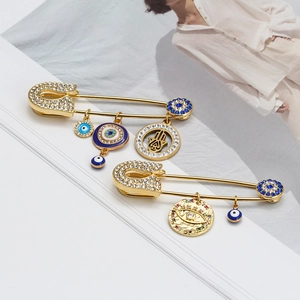Golden Evil Eye Brooch Pin with Fatima Hand charms and sparkling blue rhinestones