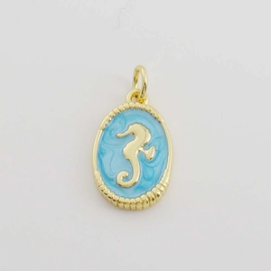 Macro view of 18K gold plated oval pendant with a seahorse relief and cyan enamel